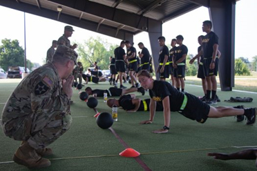 Sgt. 1st Class William Puthoff gives instruction to a Cadet from 1st Regiment, Basic Camp on technique for hand-release pushups, part of the Introduction to the Army Combat Fitness Test at Fort Knox, KY on July 5, 2021. | Photo by Griffin Amrein, CST Public Affairs