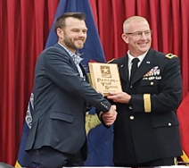 BG Scott Hipakka, Assistant Adjutant General, Michigan Army National Guard (right) presents the PaYS Partnership plaque to Tim Mitchell, Chief Operations Officer, Young Environmental Cleanup, Inc. (left).