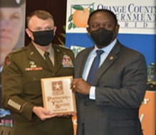 GEN Paul E. Funk II, Commanding General of TRADOC presents the Army PaYS Plaque to Jerry Demings, Orange County Mayor (Florida), during the signing ceremony