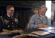 CJ Buck, CEO / Chairman, Buck Knives, Inc. with LTC Spencer Wallace, Commander, Seattle Recruiting Battalion signing the Ceremonial Memorandum of Agreement