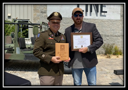 LTC Sean Bell, Commander, Jacksonville Recruiting Battalion, and Tyler Merritt, CEO, Nine Line Apparel pose with the PaYS Plaque and PaYS Certificate of Participation