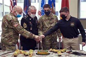 (l-r) MG Raymond Shields, Adjutant General (New York), SGM (ret) Christian Glorius, SrA Caleb Lapinel and PVT Malachy McGarry cut the National Guard birthday cake during a ceremony celebrating the birthday of the National Guard, at New York National Guard Joint Force Headquarters, Latham, N.Y. last year.