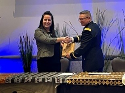 LTC Russell Clark, Commander, Texas Army National Guard Recruiting Battalion presents PaYS plaque to Anna Rogers, Assistant Corporate Direction of Human Resources, Kalahari Resort and Conventions