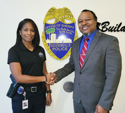 PaYS Marketer Samuel Armstrong greeting Officer Felicia Williams at Jacksonville Sheriff's Office