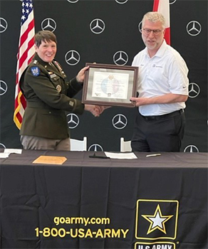 LTG Maria Gervais, Deputy Commanding General, U.S. Army Training and Doctrine Command presenting the PaYS Certificate to Mercedes-Benz U.S. International, Inc. President and CEO Michael Göbel. 