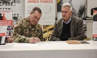 BG Moore, Assistant Adjutant General, OHARNG and Jim Krancevic, Director of Human Resources, Konecranes, Inc. sign the ceremonial Agreement.