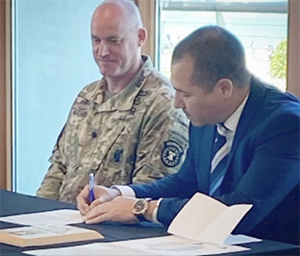 LTC Brian G. Mulhern, Commander, Southern California Recruiting Battalion and Jaret Ramirez President/COO, Bristol Management Services. Inc. signing the PaYS Ceremonial Agreement.