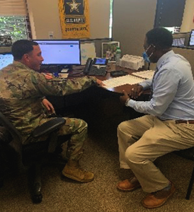 Senior Marketer Calvin Liggons with Army Guidance Counselor looking at PaYS opportunities. 