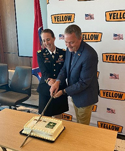 Nashville Army Recruiting BN Commander LTC Kirsten McFarland and Yellow Corporation CEO Darren Hawkins cut the cake using a ceremonial Army Saber.