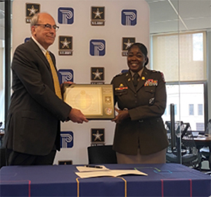 LTC Natasha Clarke, Commander New England Recruiting Battalion, presents the PaYS Plaque to Mr. William S. Mosakowski, Founder, President and CEO, Public Consulting Group