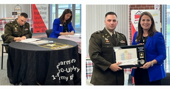 Liberty Army Recruiting Company Commander CPT Micah Robbins and Academy Bank/Armed Forces Bank Director of Military Consumer Lending, Jodi Vickery sign the PaYS Ceremonial Agreement during the signing ceremony at Ft. Leavenworth, KS. and is presented with the Certificate of Participation plaque