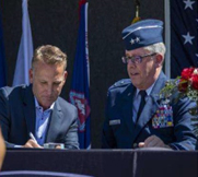 Mr. Trey Mytty, CEO, Truck Center Companies and MG Daryl Bohac, Adjutant General, Nebraska National Guard, sign the Ceremonial Agreement Form and pose with the PaYS Certificate of Participation Plaque.