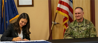 Maria Bourne, CEO and President of Denali Universal Services, signs the Memorandum of Agreement between the Alaska Army National Guard and Denali Universal Services for the PaYS Program.