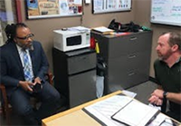 (l) PaYS Marketing Analyst Samuel discusses the PaYS Program with SGT Jay Davidge of the Glendale Police Department.