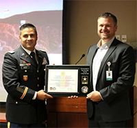 (l-r) LTC Angha and Mr. Mengenhausen--presenting the Ceremonial Plaque (l-r) LTC Angha and Mr. Mengenhausen--presenting the Ceremonial Plaque
