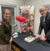 (l-r) LTC McFarland and Mr. Davis cut the cake using a ceremonial Army Saber (l-r) LTC McFarland and Mr. Davis cut the cake using a ceremonial Army Saber