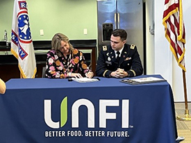 (l-r) Ms. Benedicts and CPT Waldron signing the memorandum