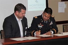 (l-r) Mr. Mengenhausen and LTC Angha signs the memorandum of agreement