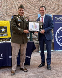 (l-r) BG Harrison presents the ceremonial plaque to Mr. Wolfburg.