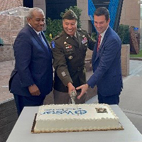 (l-r) Mr. Braswell, BG Harrison and Mr. Wolfburg cut the cake. (l-r) Mr. Braswell, BG Harrison and Mr. Wolfburg cut the cake.