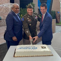 (l-r) Mr. Braswell, BG Harrison and Mr. Wolfburg cut the cake.