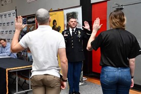 LTC Norton administering the Oath of Enlistment to two Army Future Soldiers during the BCH Mechanical PaYS Signing Ceremony.