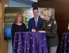 (l-r) Mrs. Holder, Mr. Sevco, and BG Krueger, sign the ceremonial certificate.