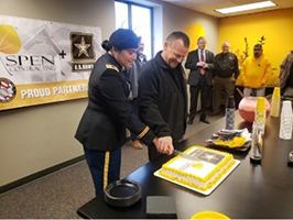 Mr. Nussbeck and CPT Chicas cut the cake at the reception following the signing ceremony.