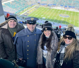 (l-r) LTC Aquino, CDT Aquino, Natalia Aquino, and Cynthia Aquino enjoying an Army college football game.