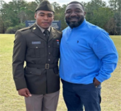 (l-r) PV2 Rodgers is congratulated by his father, LTC (R) Rodgers after graduating  Basic Training.