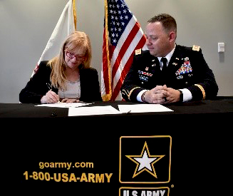 LTC Harrell and Mrs. Damerow sign the ceremonial memorandum of agreement. LTC Harrell and Mrs. Damerow sign the ceremonial memorandum of agreement.
