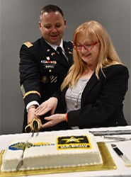Mrs. Damerow and LTC Harrell cut the cake at the reception following the signing ceremony.