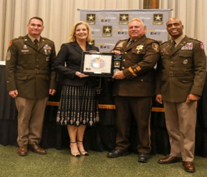 (l-r) CSM Peterson, Hon. Wormuth, Chief Leo Schmitz, Chief of Police, Cook County Sheriff’s Office, and LTC Doolan proudly presents the PaYS Ceremonial Plaque.