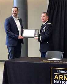 COL Fineran presents the ceremonial PaYS Partnership Plaque to Mr. Williams for Air Methods.