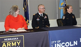 (l-r) Commissioner Yoakum, COL Weskamp and Chief Ewins take their seats at the table preparing to sign the ceremonial MOAs.