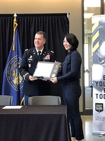 COL Fineran presents the ceremonial PaYS Partnership Plaque to Dr. Temme-Stinton for TMCO.