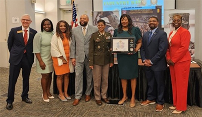 Group posing with PaYS Ceremonial plaque.