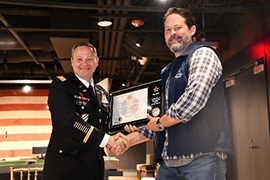 (l-r) LTC Harrel presents the ceremonial PaYS Plaque to Mr. Sweigart, a symbol of the finalized partnership. (l-r) LTC Harrel presents the ceremonial PaYS Plaque to Mr. Sweigart, a symbol of the finalized partnership.