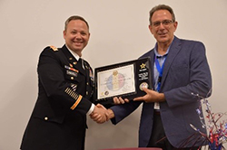 (l-r) LTC Harrell presents the ceremonial PaYS Plaque to Mr. Showah as a symbol of the finalized partnership.