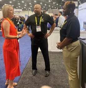 Antonio Johnson (center) and LaQuyin Brock (right) engaged with attendees to learn about their organizations and inform them on how hiring Veterans can benefit the workplace. 