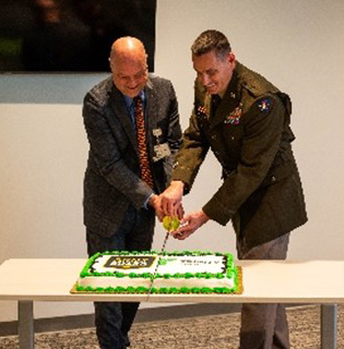 Mr. Wilson and BG Erickson cut the cake at the reception following the PaYS Signing Ceremony.