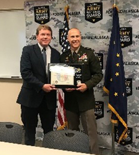 COL Brower of the AKARNG presents Mr. Anderson the PaYS Ceremonial Plaque for the Alaska Department of Transportation.