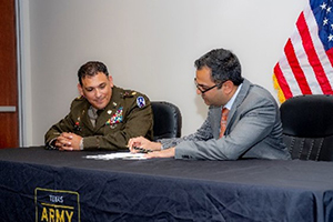 Mr. Arora and MAJ Vira sign the ceremonial PaYS Memorandum of Agreement. Mr. Arora and MAJ Vira sign the ceremonial PaYS Memorandum of Agreement.