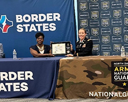 LTC Daschendorf presents the ceremonial PaYS Partnership Plaque to Mrs. Farmer for Border States.