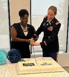 LTC Daschendorf and Mrs. Farmer cut the cake during the reception following the signing ceremony.