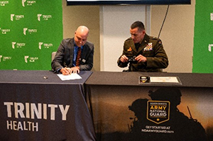 (l-r) Mr. Wilson and BG Erickson sign the ceremonial PaYS Memorandum of Agreement. (l-r) Mr. Wilson and BG Erickson sign the ceremonial PaYS Memorandum of Agreement.