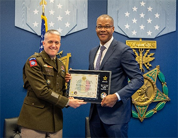 (l-r) LTG Stitt and Mr. Smith pose with the ceremonial plaque of participation agreement.