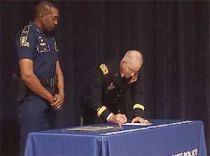 COL. Lamar Davis, Louisiana State Police, looks on as MG Waddel, Louisiana National Guard TAG, signs the Louisiana State Police ceremonial MOA.