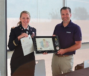 LTC Shannon Hellenbrand, Commander, WIARNG RRB present plaque to Tom Frank, CEO & President Radius Packaging