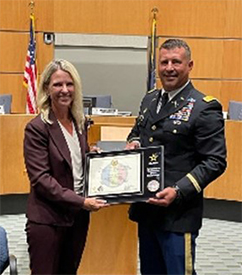 Mrs. Burmeister and MAJ Young, pose with the PaYS Ceremonial Plaque.